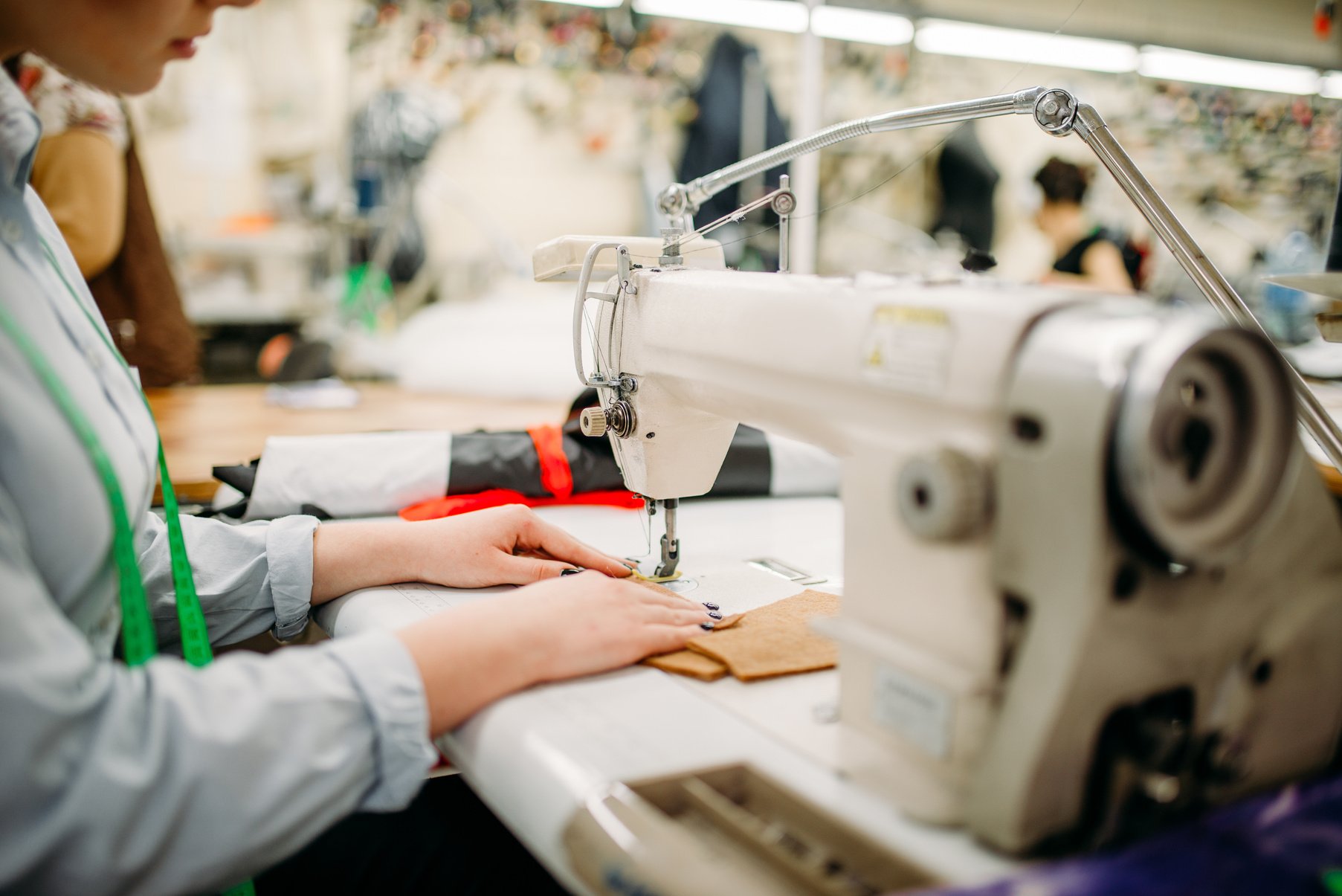 Tailor Hands Sews Fabrics on a Sewing Machine